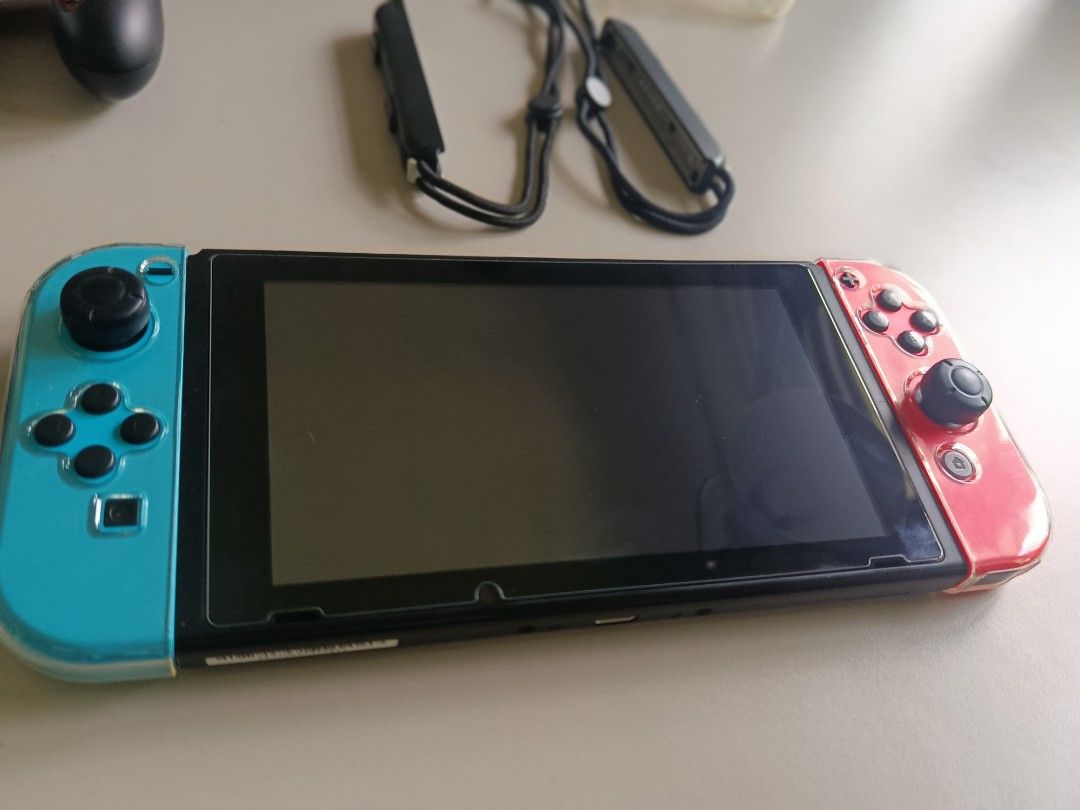 Nintendo Switch Console V2 Full Set (Category: Nintendo) located in Dasmarinas. Submitted by jannleyba (Listing ID 1467889797, Image 2). Description: - Nintendo Switch console with Neon Blue and Neon Red Joy-Cons - Complete with original box, dock, power adapter, and HDMI cable - Includes Joy-Con grip, wrist straps, carrying case, and clear protective shell - 100% working condition with normal wear on the dock and accessories location in Dasmarin