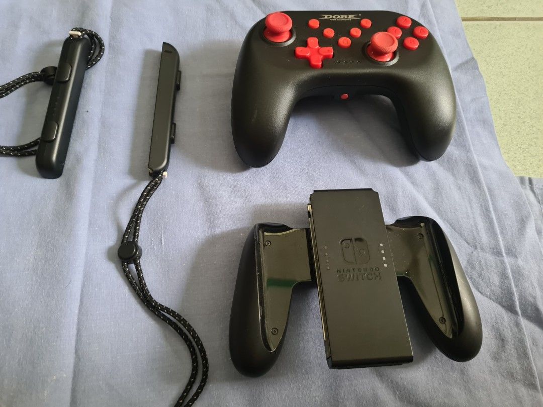 Nintendo Switch Console with Games, Controller and Case (Category: Nintendo) located in Malasiqui. Submitted by _clickmycloset (Listing ID 1468042431, Image 2). Description: Nintendo Switch oled in neon blue and red joy-cons. Includes a Dobe wireless controller, black carrying case, charging power adapter, HDMI cable, and extra grip attachments. Six physical game cartridges included: Jump Force Deluxe Edition, Resident Evil Revelations, FIFA 22 L