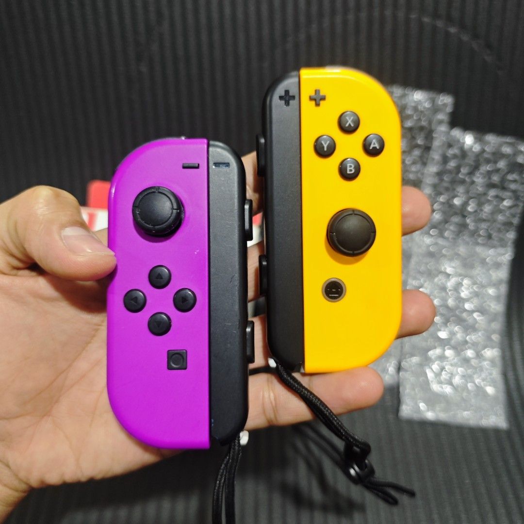 Nintendo Switch Joycon Original (Category: Controllers) located in Quezon City. Submitted by shopme_gadget30 (Listing ID 1467998063, Image 2). Description: kindly read the details first for sale fixed price Good Condition tested and working no drifting all buttons working with minor scratches only compatible to Nintendo switch v1/v2/ or oled original neon purple and neon orange but in reading is white with strap with box qc area meet up: sm north
