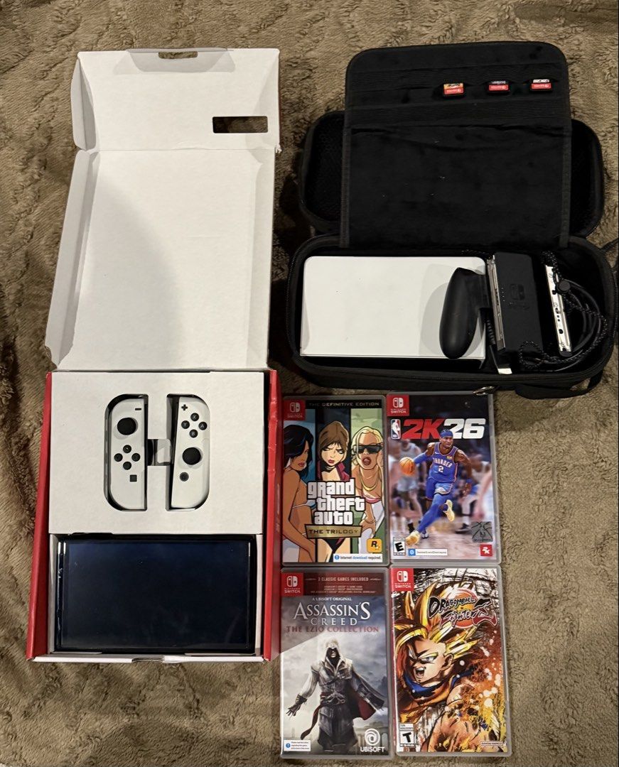Nintendo Switch OLED Model White with Games and Case (Category: Nintendo) located in Manila. Submitted by angela.pacia (Listing ID 1467978442, Image 1). Description: - Item: Nintendo Switch OLED Model (White) - Condition: Complete with original box and accessories - Included Hardware: Console, dock, white joy-cons, and black travel case - Physical Games: NBA 2K26, Grand Theft Auto The Trilogy, Assassin's Creed The Ezio Collection, and Dragon Ball