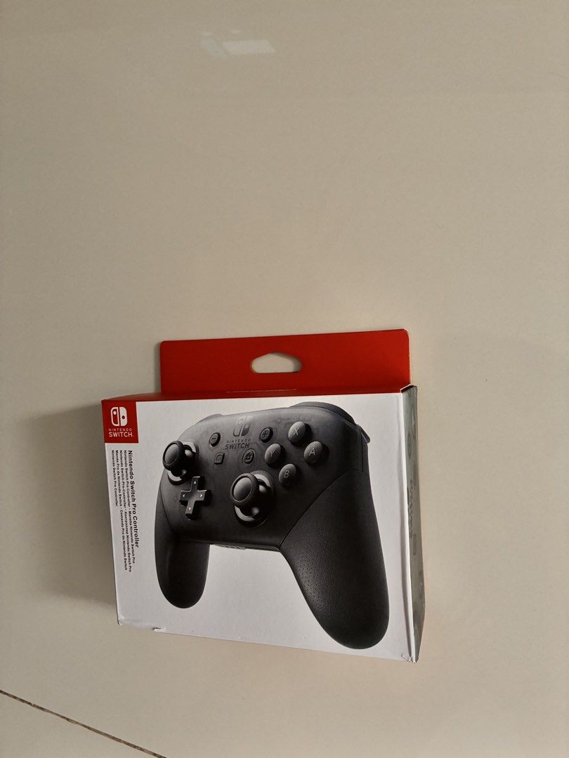 Nintendo Switch Pro Controller (Category: Controllers) located in Singapore. Submitted by chineseisnotmyforte (Listing ID 1467903340, Image 1). Description: - Official Nintendo Switch Wireless Pro Controller - Brand new in box, opened once to check but never used - Ideal for gamers who want more than joycons provide - Includes charging cable.