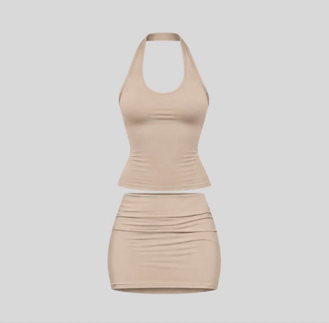 Nude Halter Top and Ruched Skirt Set (Category: Sets or Coordinates) located in Quezon City. Submitted by shaexlli (Listing ID 1468049257, Image 1). Description: - Style: Nude two-piece outfit (halter neck top and matching ruched mini skirt) - Fit: Stretchy, body-hugging material - Color: Neutral beige that easily matches anything - Versatility: Wear together or mix and match - Condition: Clean and ready to wear.