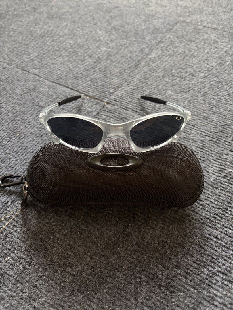 Oakley Juliet Sunglasses (Category: Sunglasses & Eyewear) located in Manila. Submitted by toys_hats005 (Listing ID 1467959261, Image 1). Description: - Brand: Oakley - Frame: Translucent clear with distinct aerodynamic lines - Lenses: Dark lenses, ideal for sunny days and outdoor sports - Inclusion: Original black textured zip hard case with classic ellipse logo - Condition: Excellent.