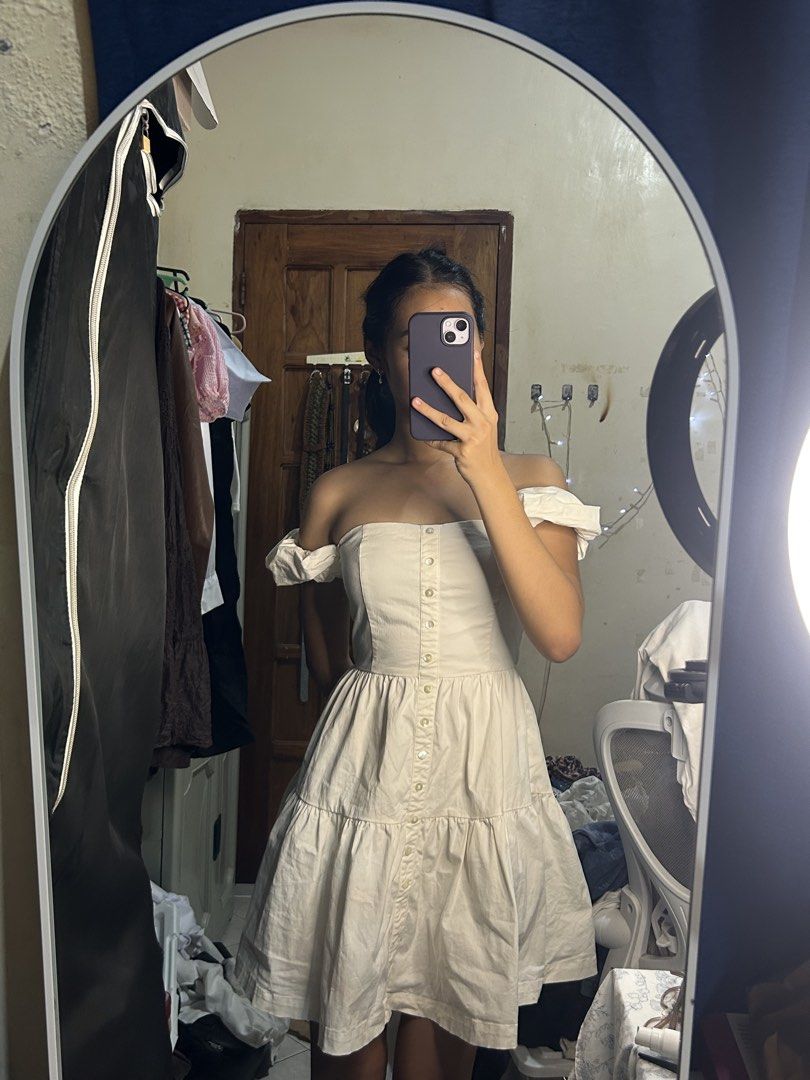 Off-shoulder beige button-front mini dress (Category: Dresses) located in Tuguegarao City. Submitted by eliwyxzs (Listing ID 1467840961, Image 1). Description: - Color: Light cream / beige - Style: Off-shoulder mini dress with puffy short sleeves - Details: Functional front button closure, fitted bodice, and a tiered flared skirt - Fit: Structured and flattering - Occasion: Ideal for casual days out and weekend wear.