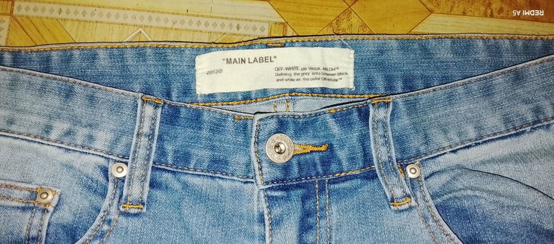 Off-White Blue Denim Jeans with White Leg Print (Category: Jeans) located in Pila. Submitted by franklinsanity (Listing ID 1467853882, Image 3). Description: - Brand: Off-White - Wash: Light / Medium Blue Denim - Fit: Straight leg - Design: Classic 5-pocket styling with zip fly and branded button - Detail: Large vertical white Off-White logo print on the left lower leg authencity: OFF (not authentic) Size: waist - 30" outseam - 40" inseam - 30" l