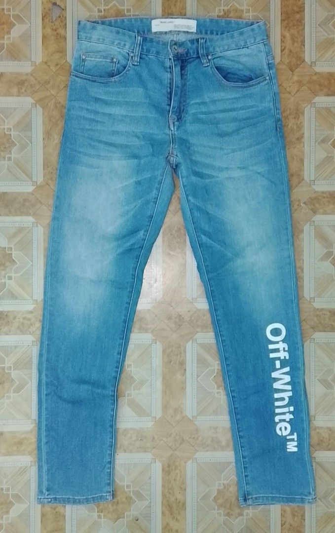 Off-White Blue Denim Jeans with White Leg Print (Category: Jeans) located in Pila. Submitted by franklinsanity (Listing ID 1467853882, Image 1). Description: - Brand: Off-White - Wash: Light / Medium Blue Denim - Fit: Straight leg - Design: Classic 5-pocket styling with zip fly and branded button - Detail: Large vertical white Off-White logo print on the left lower leg authencity: OFF (not authentic) Size: waist - 30" outseam - 40" inseam - 30" l