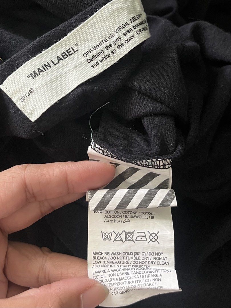 Off-White Fahrenheit 451 Black Tee (Category: Tshirts & Polo Shirts ) located in Naga. Submitted by rmapprl (Listing ID 1467944628, Image 2). Description: - Off-White black t-shirt designed by Virgil Abloh - Features iconic Fahrenheit 451 graphic and signature yellow diagonal arrows on the back - Subtle OFF logo text on the front collar - Tagged size XS, but fits oversized up to a Large (22 x 27 inches) - Premium 100% cotton construction, Made in