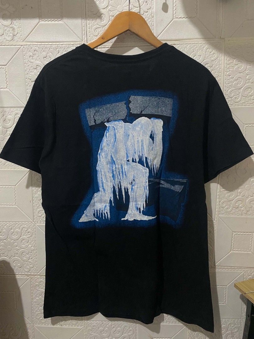 Off-White Impressionism 99 Black T-Shirt (Category: Tshirts & Polo Shirts ) located in Koronadal. Submitted by thrifturight (Listing ID 1467997919, Image 2). Description: - Brand: Off-White (Impressionism Collection) - Color: Black - Size: Large - Material: 100% Cotton - Design Front: Big "99" print with subtle branding - Design Back: Large blue frozen figure graphic - Fit: Classic crew neck and short sleeves - Condition: Excellent, carefully sto