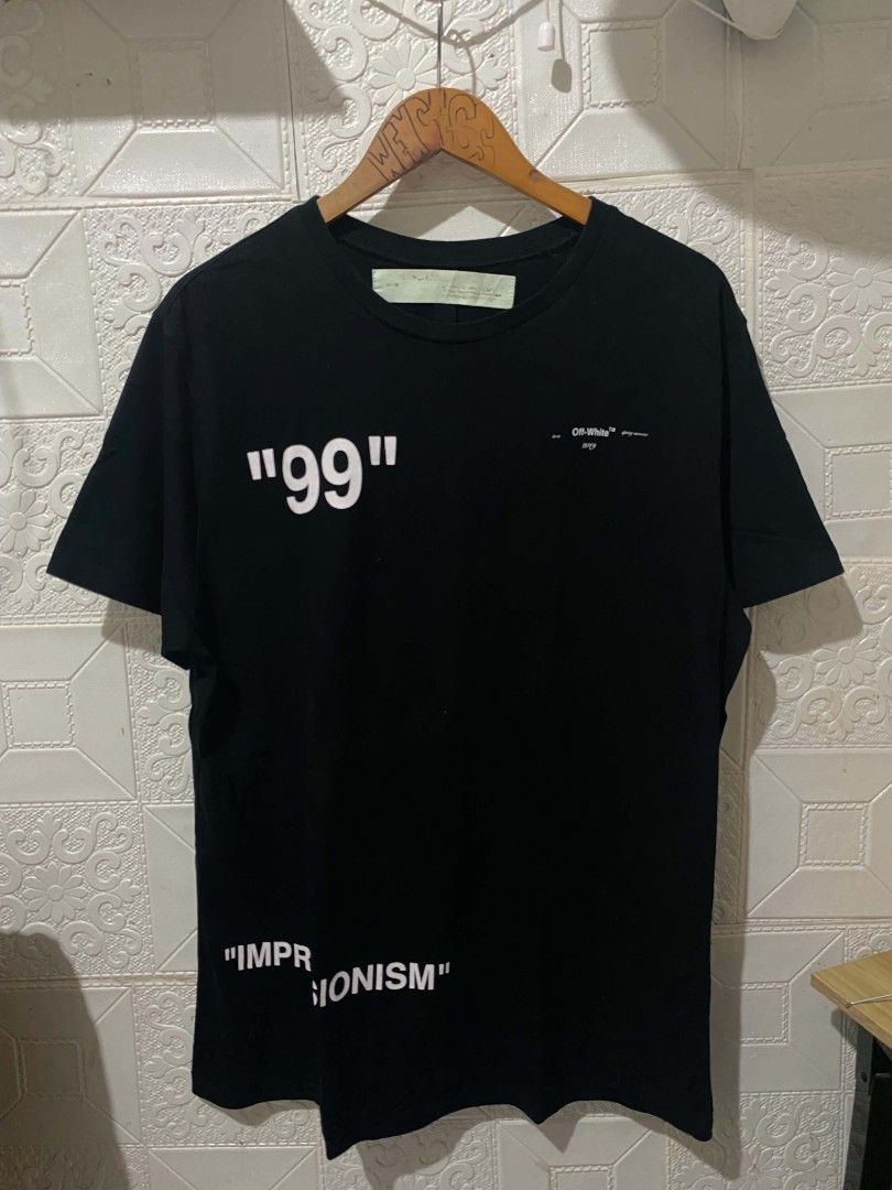 Off-White Impressionism 99 Black T-Shirt (Category: Tshirts & Polo Shirts ) located in Koronadal. Submitted by thrifturight (Listing ID 1467997919, Image 1). Description: - Brand: Off-White (Impressionism Collection) - Color: Black - Size: Large - Material: 100% Cotton - Design Front: Big "99" print with subtle branding - Design Back: Large blue frozen figure graphic - Fit: Classic crew neck and short sleeves - Condition: Excellent, carefully sto