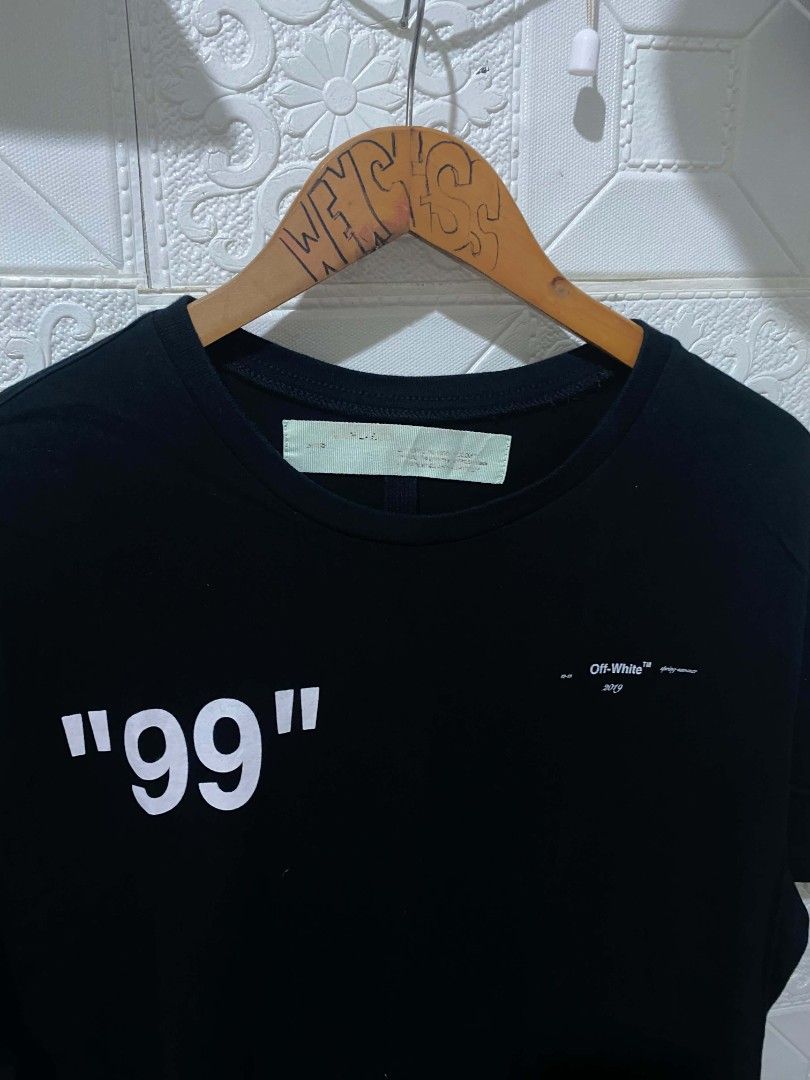 Off-White Impressionism 99 Black T-Shirt (Category: Tshirts & Polo Shirts ) located in Koronadal. Submitted by thrifturight (Listing ID 1467997919, Image 3). Description: - Brand: Off-White (Impressionism Collection) - Color: Black - Size: Large - Material: 100% Cotton - Design Front: Big "99" print with subtle branding - Design Back: Large blue frozen figure graphic - Fit: Classic crew neck and short sleeves - Condition: Excellent, carefully sto