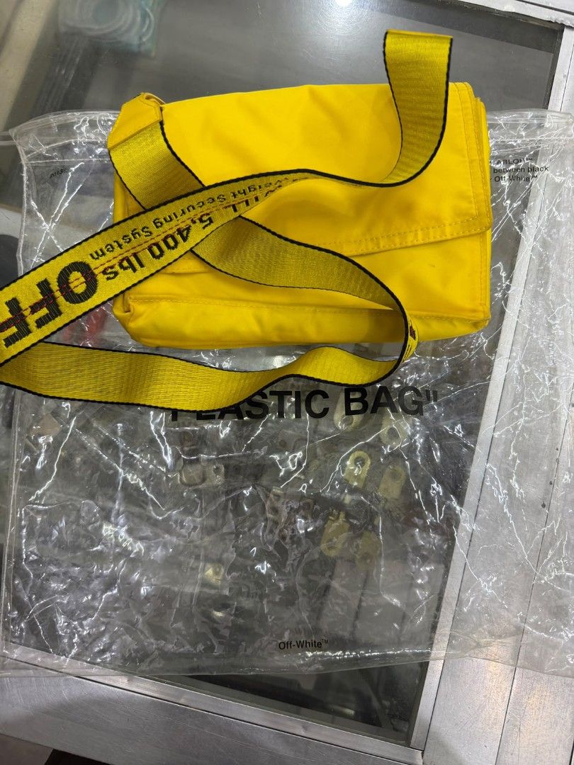 Off-White Yellow Crossbody Bag (Category: Cross-body Bags) located in Manila. Submitted by gmfhardware (Listing ID 1467839642, Image 1). Description: - Authentic Off-White crossbody bag in bright yellow - Contrasting light green interior lining with branded text pattern - Secure zip closure and snap button details - Includes functional inner zip pockets - Adjustable signature yellow industrial strap - Made in Italy tag intact - Clean canvas body,