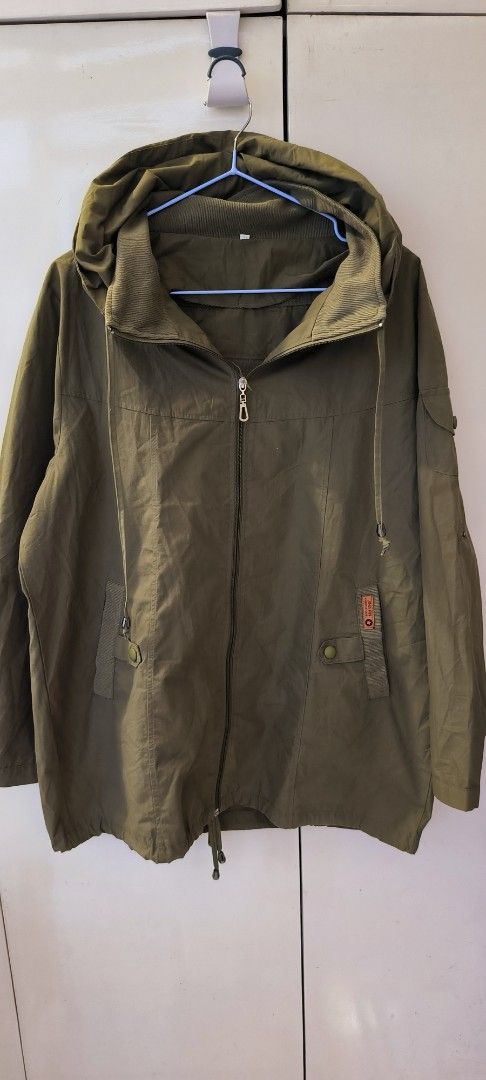 Olive green hooded jacket with front pockets and drawstrings (Category: Coats, Jackets and Outerwear) located in Paranaque City. Submitted by lizpretty05 (Listing ID 1467842135, Image 1). Description: - Color: Olive green - Closure: Full zip front - Pockets: Two lower snap-button pockets plus a left arm sleeve pocket - Comfort: Ribbed collar lining for extra warmth - Fit: Adjustable drawstrings at the hood and bottom hem - Style: Casual utility l
