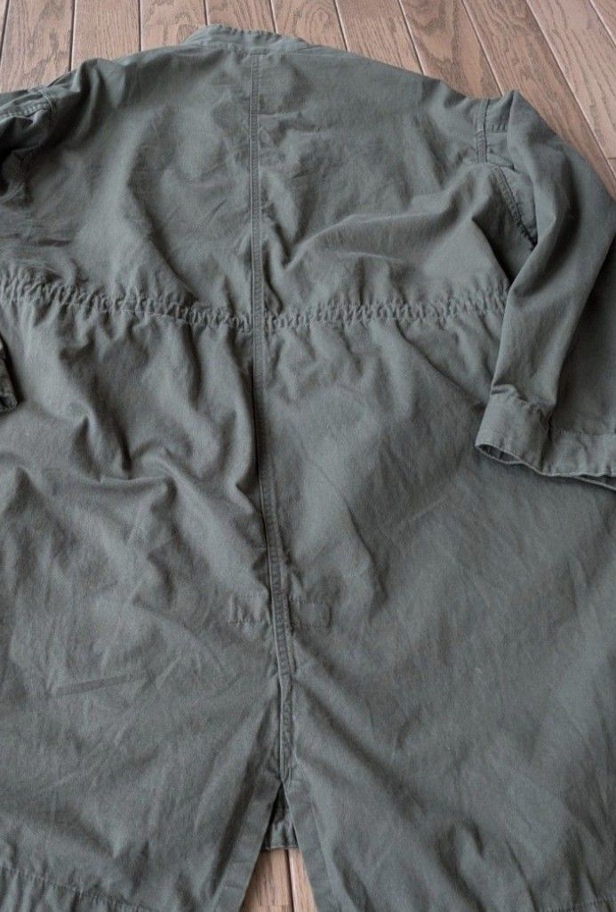 Olive green military style parka utility jacket (Category: Coats, Jackets and Outerwear) located in Caloocan City. Submitted by wan_l_as (Listing ID 1467846290, Image 1). Description: - Color: Olive green with neutral earth-tone chest patches - Fit: Relaxed fit, ideal for layering - Closure: Front zipper and button closure with a stand-up collar - Details: Adjustable drawstrings at the waist and bottom hem, plus a fishtail back hem - Pockets: Fun