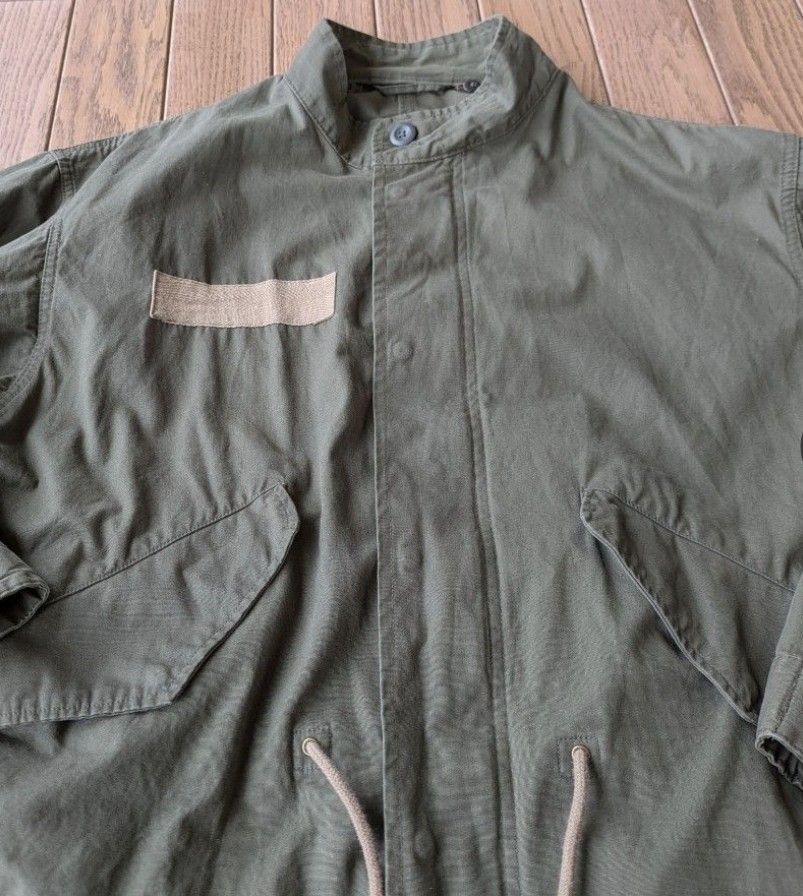 Olive green military style parka utility jacket (Category: Coats, Jackets and Outerwear) located in Caloocan City. Submitted by wan_l_as (Listing ID 1467846290, Image 3). Description: - Color: Olive green with neutral earth-tone chest patches - Fit: Relaxed fit, ideal for layering - Closure: Front zipper and button closure with a stand-up collar - Details: Adjustable drawstrings at the waist and bottom hem, plus a fishtail back hem - Pockets: Fun