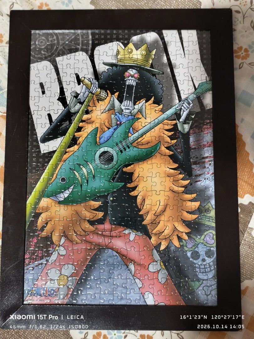 One Piece Brook Framed Jigsaw Puzzle (Category: Board Games & Puzzles) located in Mapandan. Submitted by marc.bno (Listing ID 1467889989, Image 1). Description: - Completed One Piece jigsaw puzzle featuring Brook with guitar and crown - Already assembled and mounted in a stylish dark brown wooden frame - Comes with a built-in hanging string on the back panel - 100% ready to hang straight on your wall - Perfect for anime fans and room decor.