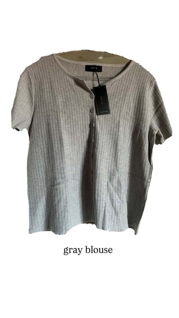 ONE-K Ribbed Button-Down Knitted Short Sleeve Blouse Top (Category: Blouses) located in Marikina City. Submitted by savemyclosetph (Listing ID 1467946488, Image 2). Description: - Brand: ONE-K (Brand New with Tags) - Style: Ribbed knit blouse with short sleeves and front button closure - Neckline: Scoop neckline - Colors Available: Gray, Black, Beige - Condition: 100% Brand New - Perfect for casual days, work, or smart-casual looks! - Small to La