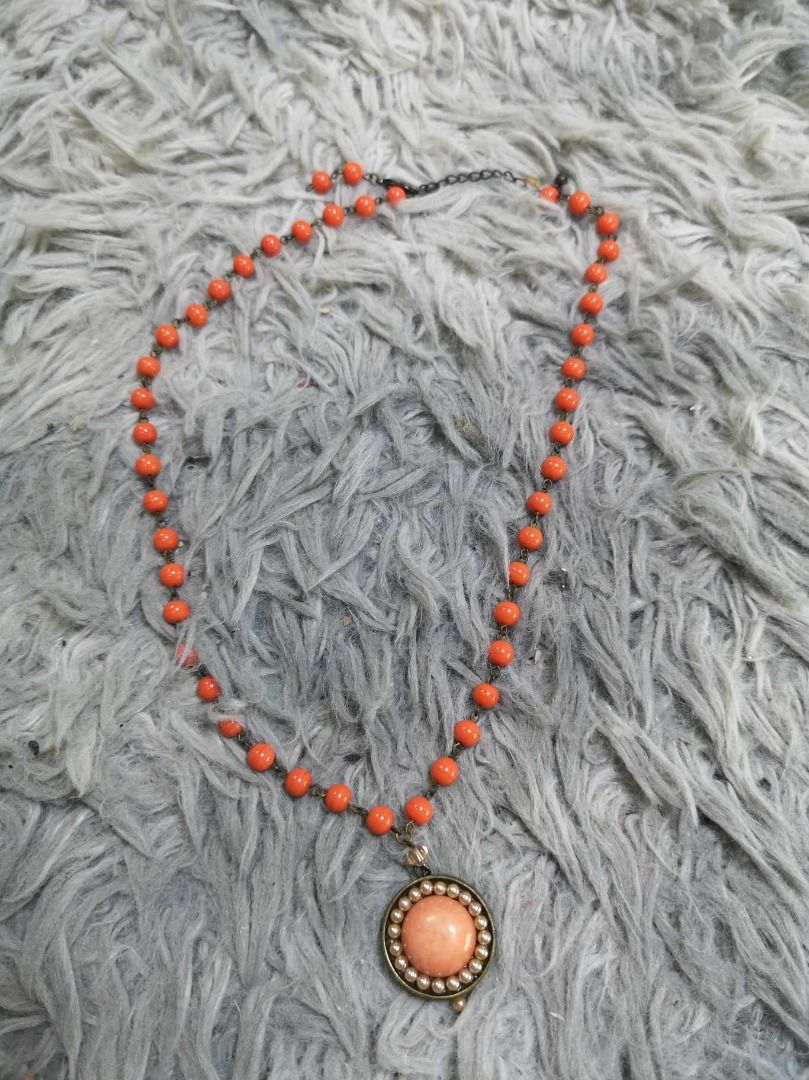 Orange Beaded Round Pendant Light Colored Central Stone Necklace (Category: Necklaces) located in Santa Cruz. Submitted by jmy_surplus.2 (Listing ID 1467904562, Image 1). Description: Size : - L - 10 W - 1 Color : Orange Type : Necklace Brand : No Brand Material : Pearl Style : Orange Beaded Necklace LG 117 JMY3 Batch #225.