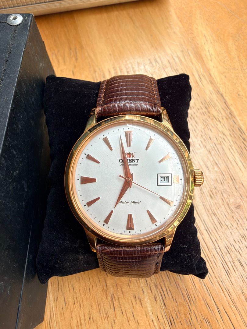 Orient Bambino Automatic Watch Rose Gold White Dial Leather Strap (Category: Men's Watches) located in Quezon City. Submitted by 30somethingtreasures (Listing ID 1467986491, Image 2). Description: - Brand: Orient Automatic Dress Watch - Dial: White dial with date window at 3 o'clock - Case: Rose gold tone case with stainless steel transparent exhibition back - Strap: Premium textured brown leather strap - Condition: Keeps excellent time - Inclusi