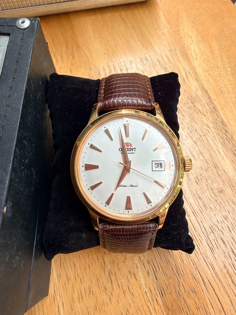 Orient Bambino Automatic Watch Rose Gold White Dial Leather Strap (Category: Men's Watches) located in Quezon City. Submitted by 30somethingtreasures (Listing ID 1467986491, Image 1). Description: - Brand: Orient Automatic Dress Watch - Dial: White dial with date window at 3 o'clock - Case: Rose gold tone case with stainless steel transparent exhibition back - Strap: Premium textured brown leather strap - Condition: Keeps excellent time - Inclusi