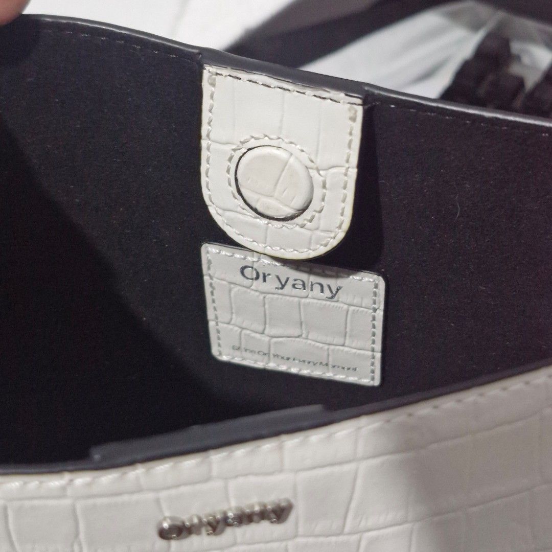 ORYANY White Shoulder Bag (Category: Shoulder Bags) located in Manila. Submitted by aimy_amour (Listing ID 1468028952, Image 3). Description: Preloved Oryany shoulder bag with dust bag. Has light yellow stains from usage but has no other flaws.