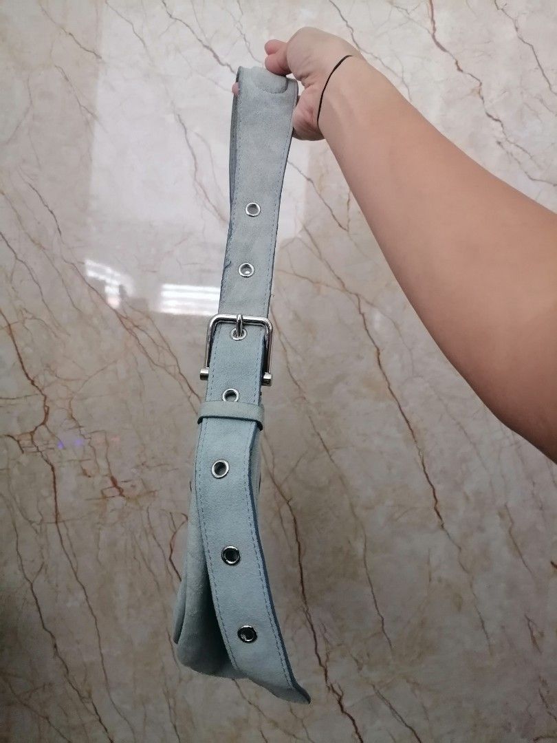 Osoi Suede Shoulder Bag Light Blue (Category: Shoulder Bags) located in Digos. Submitted by crodualady82694 (Listing ID 1467880508, Image 3). Description: - Brand: Osoi - Material: Suede - Color: Light Blue - Design: Sleek crescent silhouette with clean lines - Hardware: Chunky silver buckle strap with eyelet detailing and stamped logo - Closure: Secure zip top - Interior: Lined with a convenient slip pocket - Condition: Excellent overall shape.