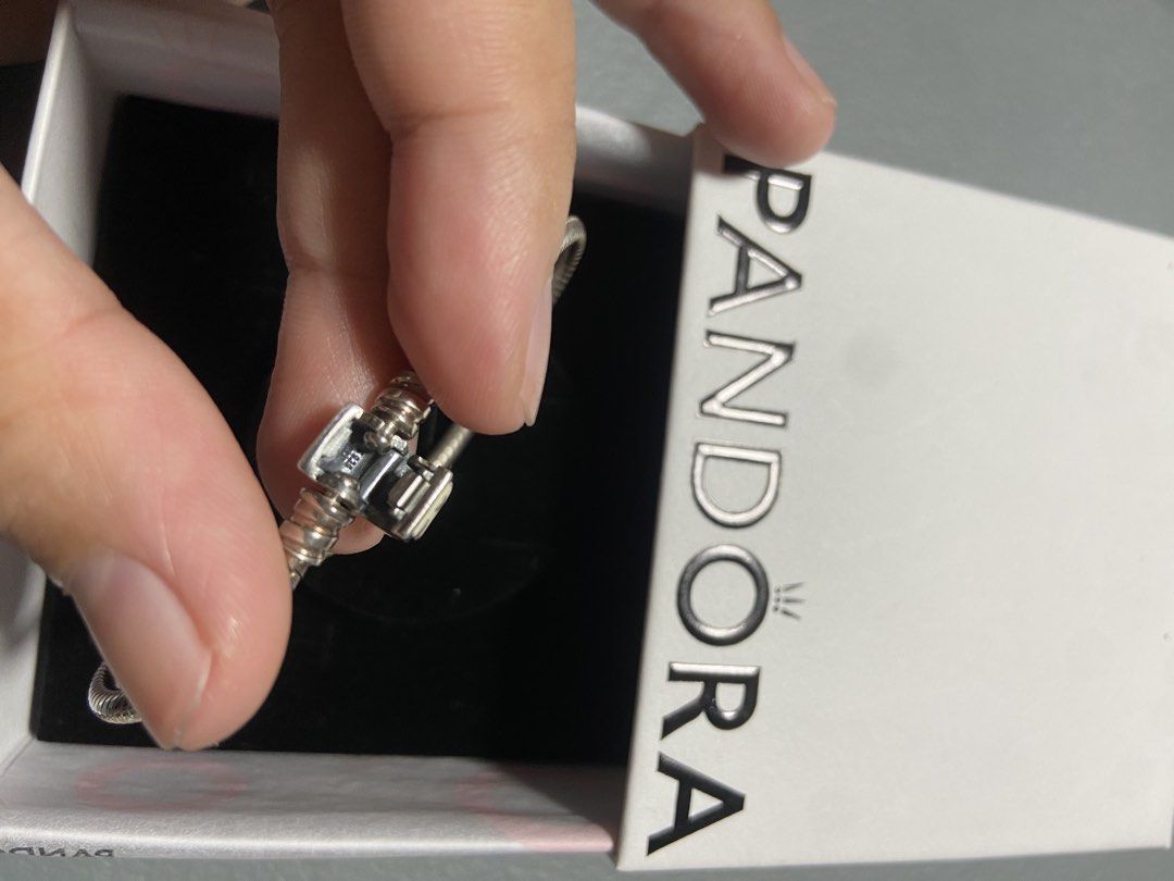 Pandora Silver Charm Bracelet with Box (Category: Bracelets) located in Caloocan City. Submitted by -kristine- (Listing ID 1467979998, Image 2). Description: - 100% authentic Pandora silver snake chain bracelet - Includes original branded white storage box - Features a special 'MOM' engraved charm with white enamel detail - Secure barrel clasp closure with authentic hallmarks inside.
