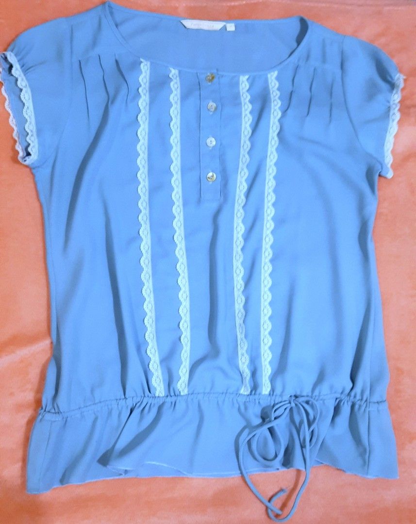 Paper Dolls Blue Lace Trim Button Blouse Medium (Category: Blouses) located in Manila. Submitted by declutter.mnla (Listing ID 1467999605, Image 1). Description: - Brand: Paper Dolls - Size: M - Color: Light blue - Details: Front button placket with 4 pearlescent buttons, white lace trim panels on the chest, gathered neckline, and elasticated drawstring hem - Style: Cute and casual, perfect for warm weather - Condition: Excellent.