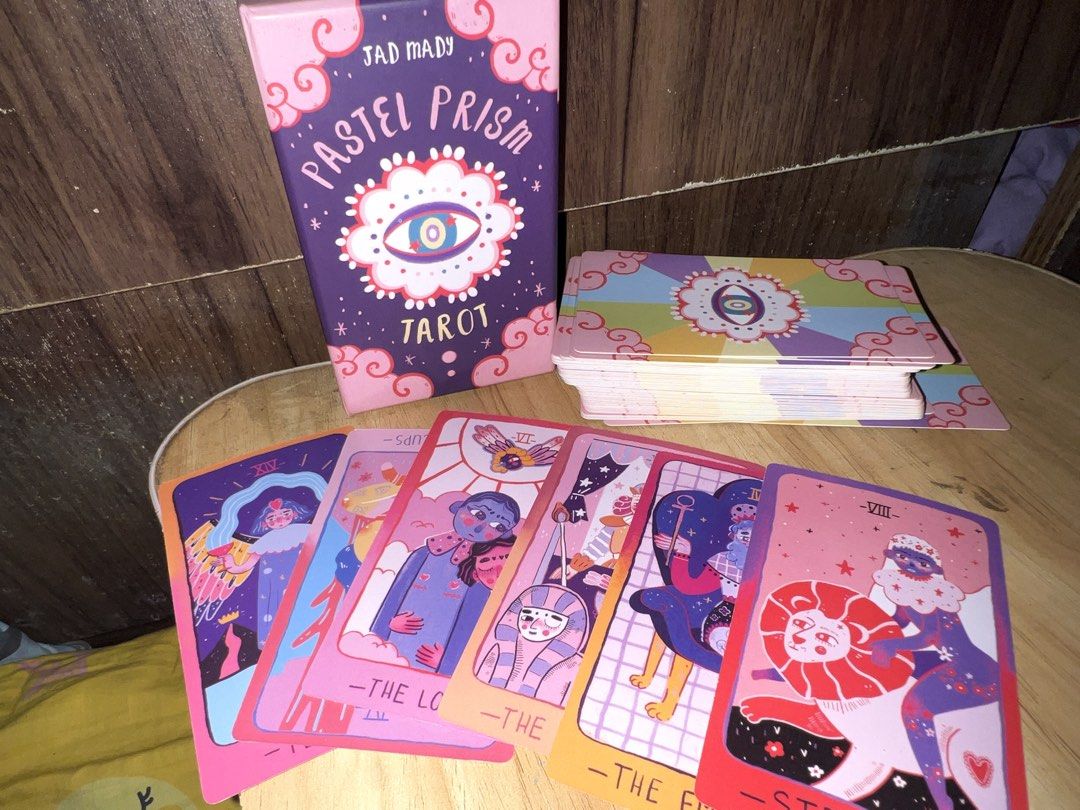 Pastel Prism Tarot by Jad Mady (Category: Storybooks) located in Manila. Submitted by va1nblxxd (Listing ID 1467993335, Image 3). Description: — High Quality [All cards complete] — Barely used at all because i got other tarot card decks lol. — Cleansed ! — super negotiable selling price, needa get rid of it for spacee • Originally bought for: 2.5k PHP Reason for Selling: As mentioned previously i am making spaces for other decks, and i barely use