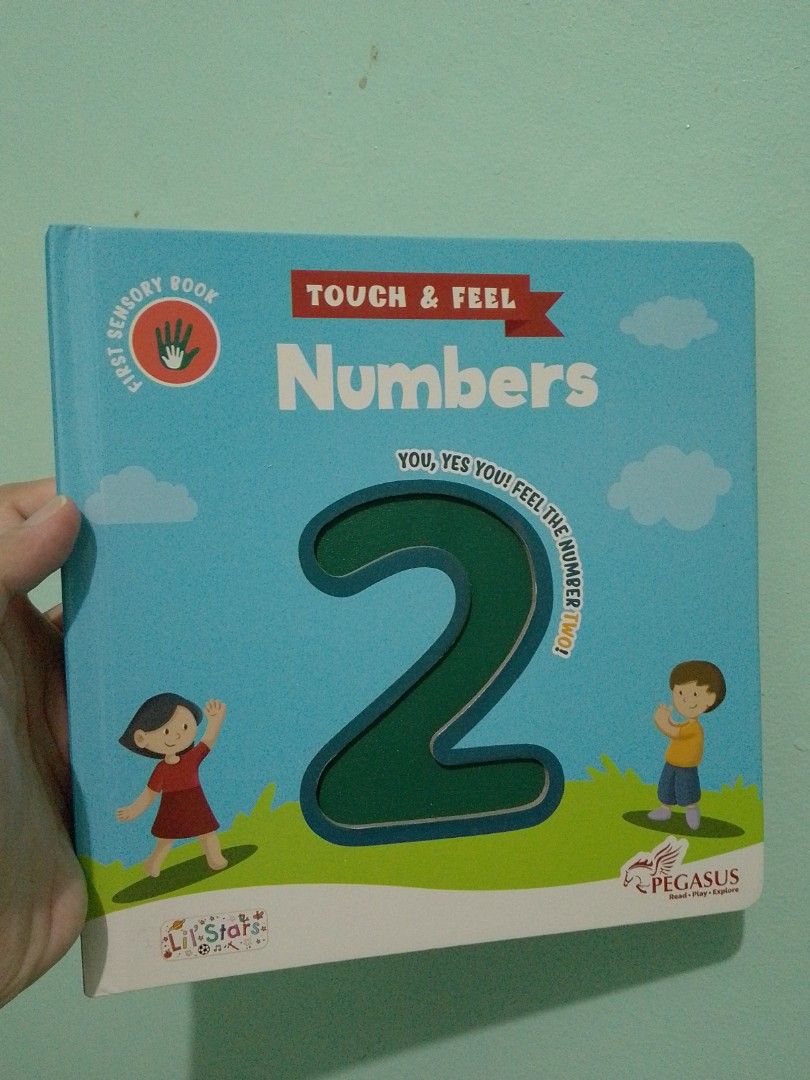 Pegasus Touch & Feel Numbers Sensory Book (Category: Children's Books) located in Ligao. Submitted by zeeyans_nook (Listing ID 1467923369, Image 1). Description: - Title: Pegasus Touch & Feel Numbers Sensory Book - Format: Sturdy board book with a bright blue cover - Features: Interactive tactile numbers on every page for hands-on learning - Visuals: Colorful animal illustrations and fun facts to keep kids engaged - Bonus: Includes a free app acc