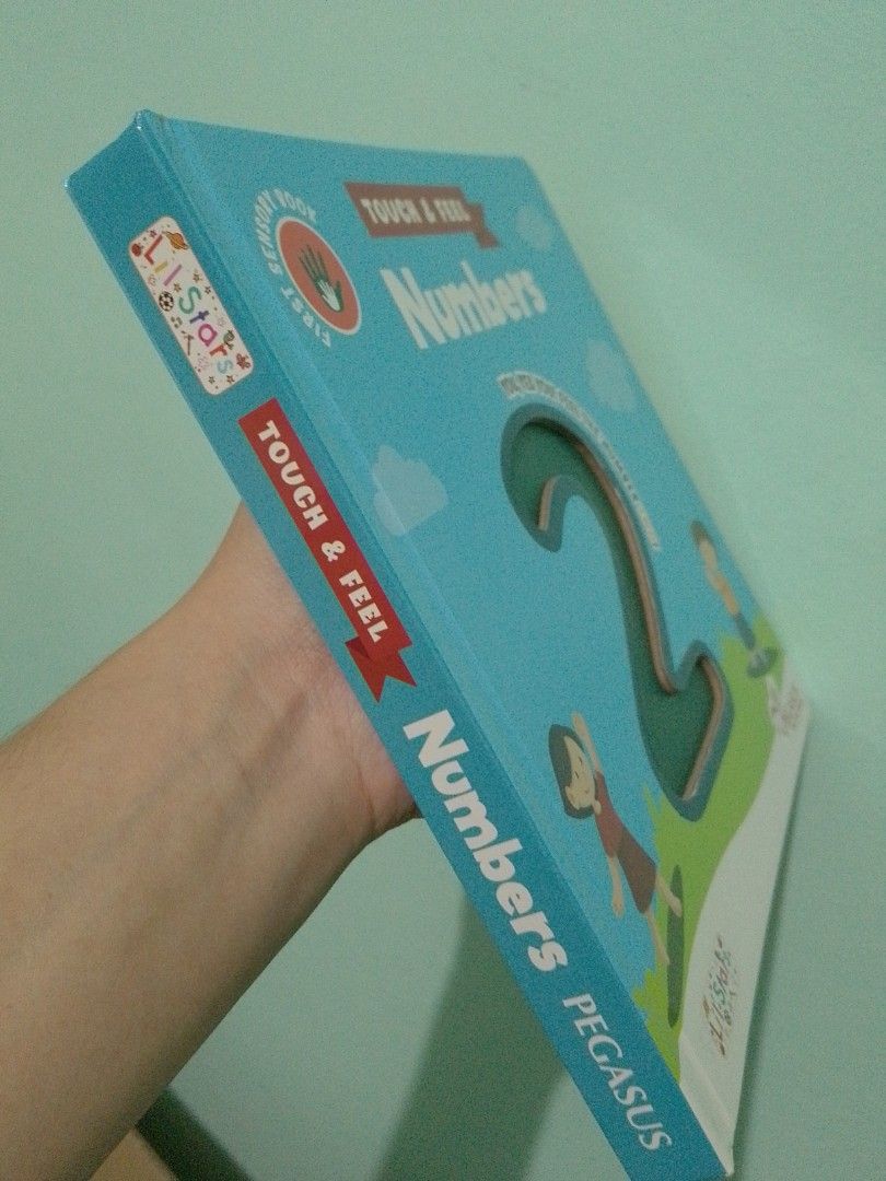Pegasus Touch & Feel Numbers Sensory Book (Category: Children's Books) located in Ligao. Submitted by zeeyans_nook (Listing ID 1467923369, Image 3). Description: - Title: Pegasus Touch & Feel Numbers Sensory Book - Format: Sturdy board book with a bright blue cover - Features: Interactive tactile numbers on every page for hands-on learning - Visuals: Colorful animal illustrations and fun facts to keep kids engaged - Bonus: Includes a free app acc