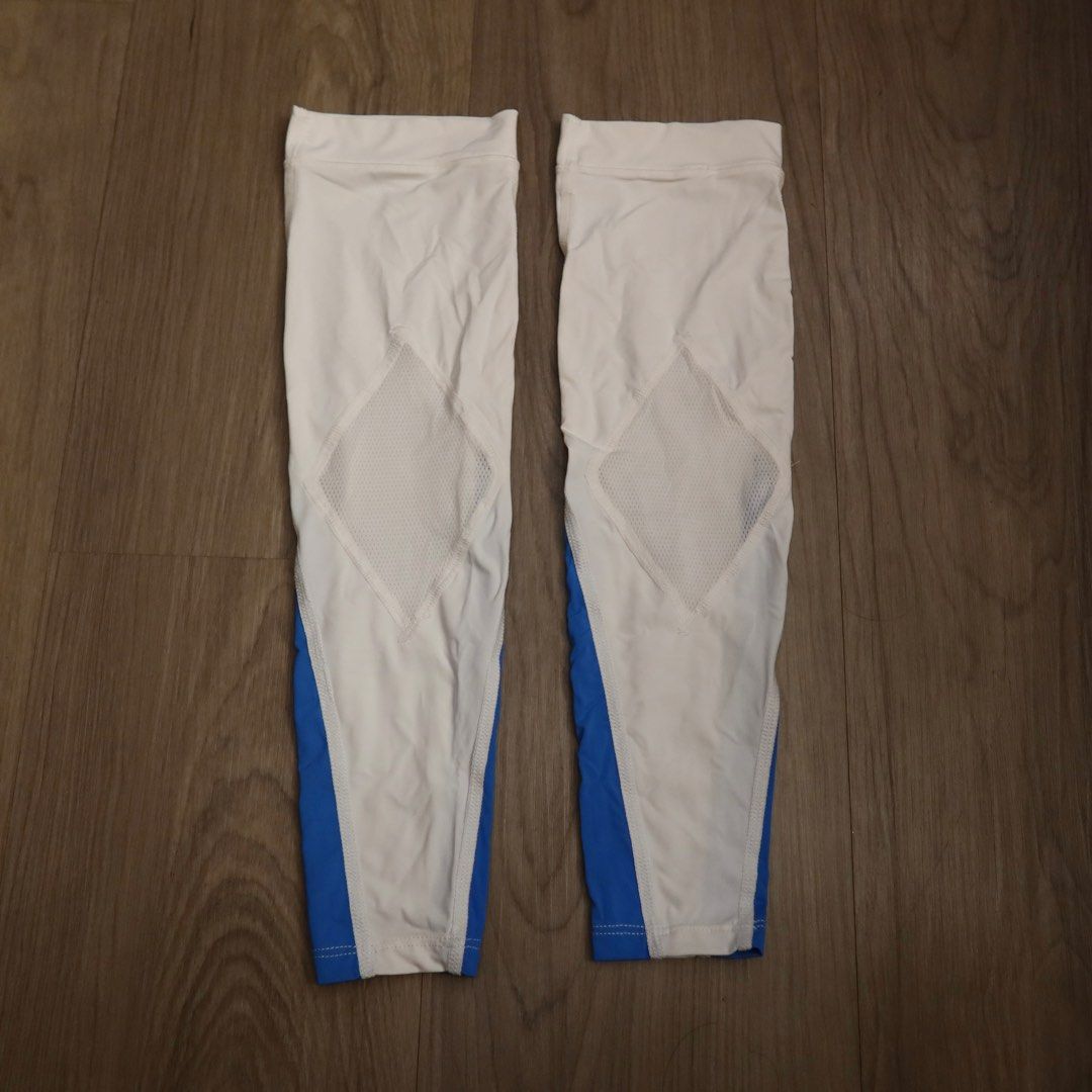 Performance Gear White and Blue Calf Sleeves (Category: Activewear) located in Manila. Submitted by gentlewind_62f064 (Listing ID 1467925256, Image 2). Description: - Brand: Performance Gear (PG) - Color: White and blue with black branding - Material: Stretchy athletic fabric - Feature: Breathable mesh diamond panel on the back for ventilation - Inset: Sold as a pair (2 sleeves) - Ideal for basketball, running, cycling, and general workouts.