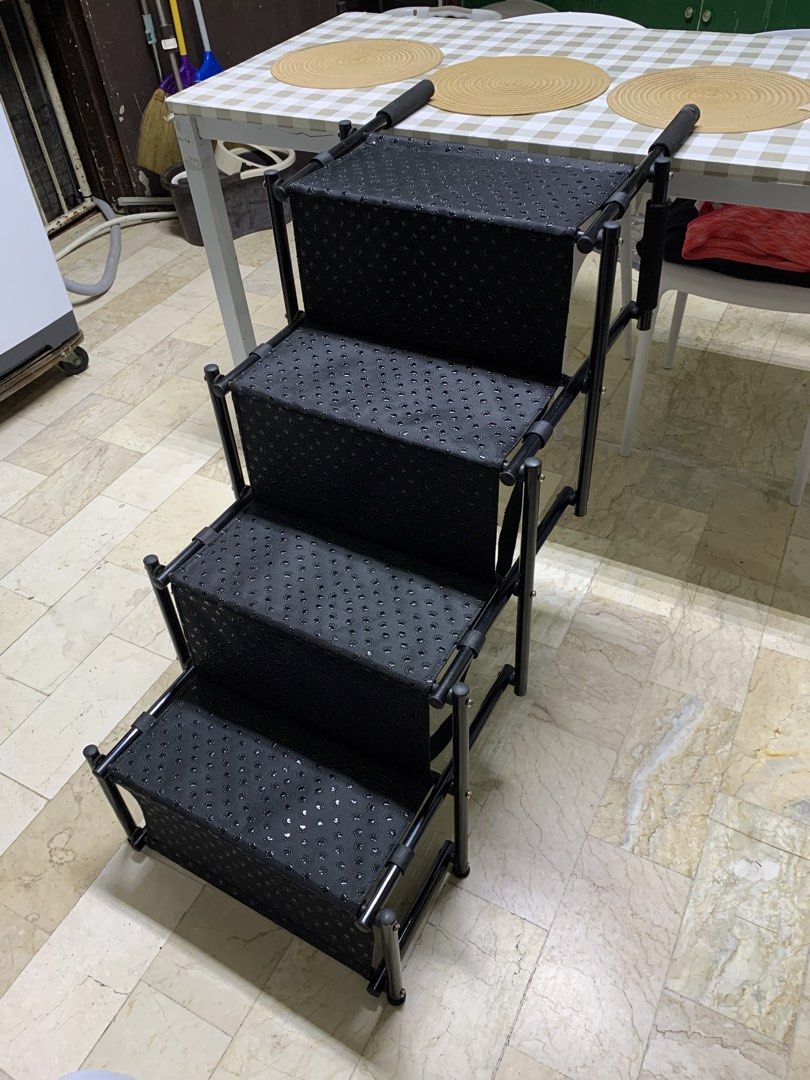 Petsafe Foldable 4-Step Portable Pet Stairs Black with Paw Print Pattern (Category: Ladders & Steps) located in Paranaque City. Submitted by seb_trading (Listing ID 1467926177, Image 2). Description: - Color: Sleek black with cute paw print pattern on treads - Ideal For: Small dogs and cats, especially senior pets needing help reaching beds or couches - Sturdy Design: Durable metal frame with comfortable foam/fabric steps - Convenient Features: P