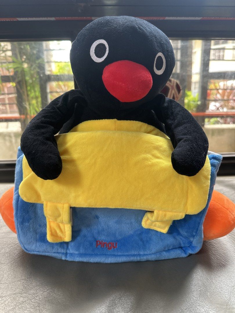 Pingu Plush Backpack Soft Toy Penguin Bag (Category: Plushies & Soft Toys) located in Cainta. Submitted by shopbyyna (Listing ID 1467864696, Image 1). Description: - Super cute Pingu plush backpack - Soft black and white body with bright orange feet and a big red beak - Front blue and yellow pouch compartment with 'Pingu' embroidered in red - Adjustable black straps for a comfortable fit - Fun conversation starter or quirky everyday carry-all.