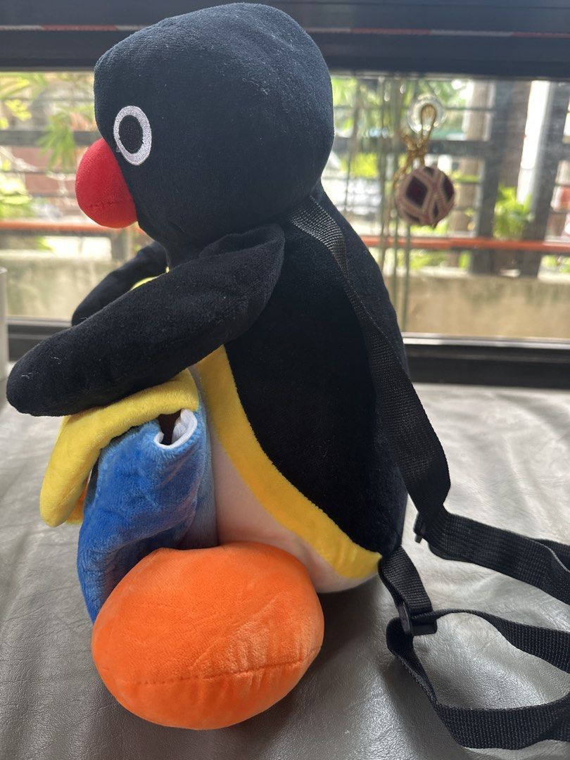 Pingu Plush Backpack Soft Toy Penguin Bag (Category: Plushies & Soft Toys) located in Cainta. Submitted by shopbyyna (Listing ID 1467864696, Image 3). Description: - Super cute Pingu plush backpack - Soft black and white body with bright orange feet and a big red beak - Front blue and yellow pouch compartment with 'Pingu' embroidered in red - Adjustable black straps for a comfortable fit - Fun conversation starter or quirky everyday carry-all.