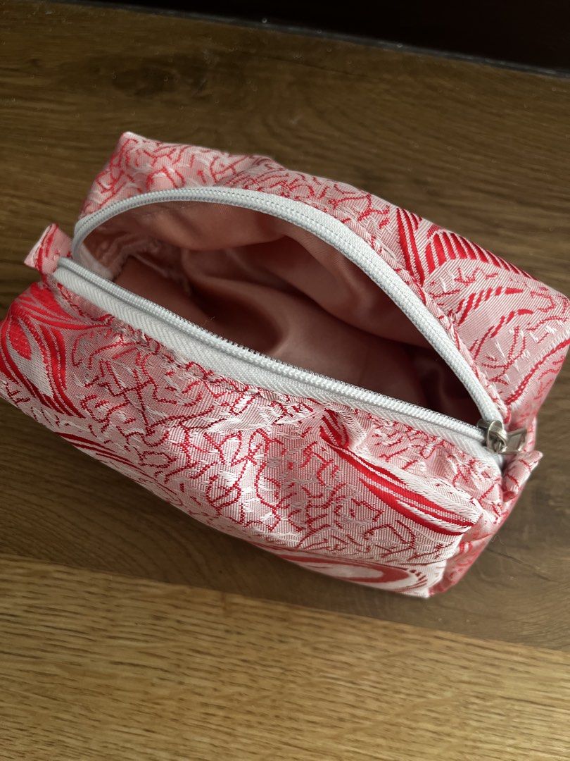 Pink and Red Patterned Makeup Pouch (Category: Purses & Pouches) located in San Fernando. Submitted by angelhave_wings (Listing ID 1468058160, Image 2). Description: - Trendy pink and red abstract swirl design - Secure white zipper closure across the top - Fully lined with soft pink fabric inside - Maintains a structured shape even when open - Compact and perfect for organizing your makeup and daily essentials.