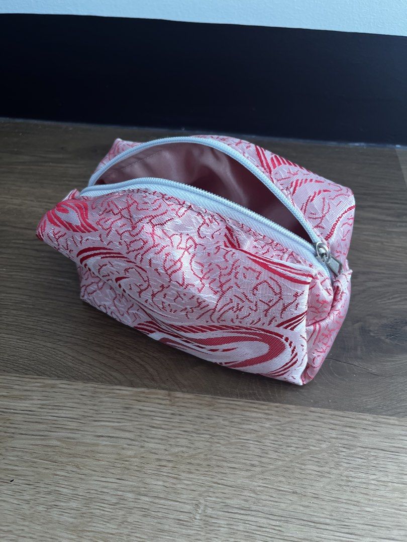 Pink and Red Patterned Makeup Pouch (Category: Purses & Pouches) located in San Fernando. Submitted by angelhave_wings (Listing ID 1468058160, Image 3). Description: - Trendy pink and red abstract swirl design - Secure white zipper closure across the top - Fully lined with soft pink fabric inside - Maintains a structured shape even when open - Compact and perfect for organizing your makeup and daily essentials.