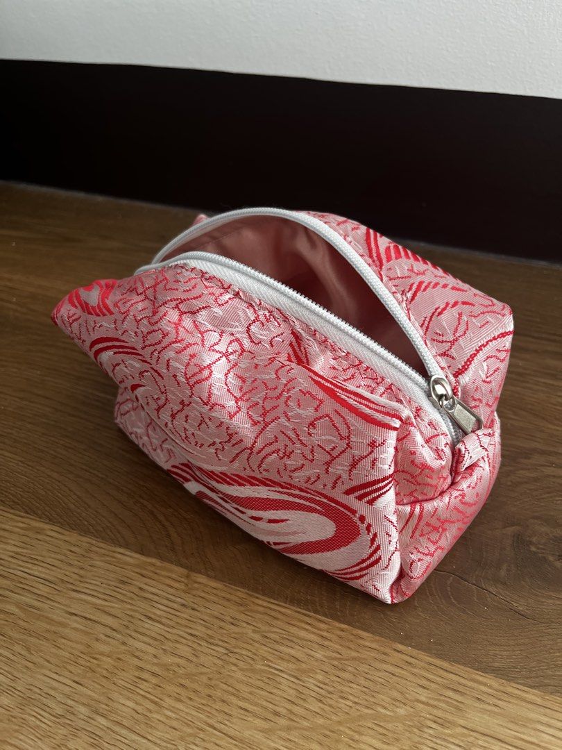 Pink and Red Patterned Makeup Pouch (Category: Purses & Pouches) located in San Fernando. Submitted by angelhave_wings (Listing ID 1468058160, Image 1). Description: - Trendy pink and red abstract swirl design - Secure white zipper closure across the top - Fully lined with soft pink fabric inside - Maintains a structured shape even when open - Compact and perfect for organizing your makeup and daily essentials.