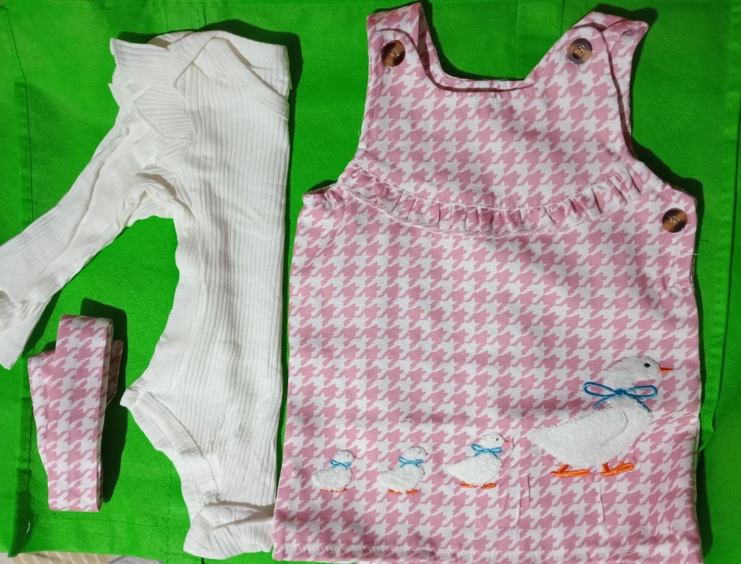 Pink and White Houndstooth Duck Tunic Top (Category: Other Babies Going Out Needs) located in Quezon City. Submitted by macon0948 (Listing ID 1467894228, Image 1). Description: - Pink and white houndstooth pattern - Adorable embroidered mother duck and ducklings with blue bows at the bottom - Sweet ruffle trim across the chest - Convenient button closures at the shoulders and side - Sleeveless design - Chest width: approx. 13 inches.