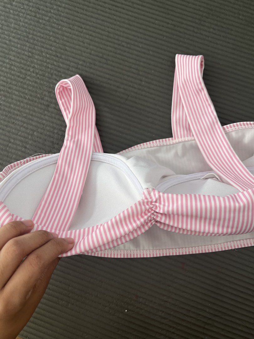 Pink and White Striped Bikini Top with Ruched Front (Category: Bikinis & Swimsuits) located in San Fernando. Submitted by angelhave_wings (Listing ID 1468058209, Image 3). Description: - Pink and white vertical stripe design - Sweetheart neckline with a cute ruched center twist - Fixed shoulder straps and pullover style - Built-in padding for support and shape - Fully lined in clean white fabric - Ideal for beach trips and pool lounging.