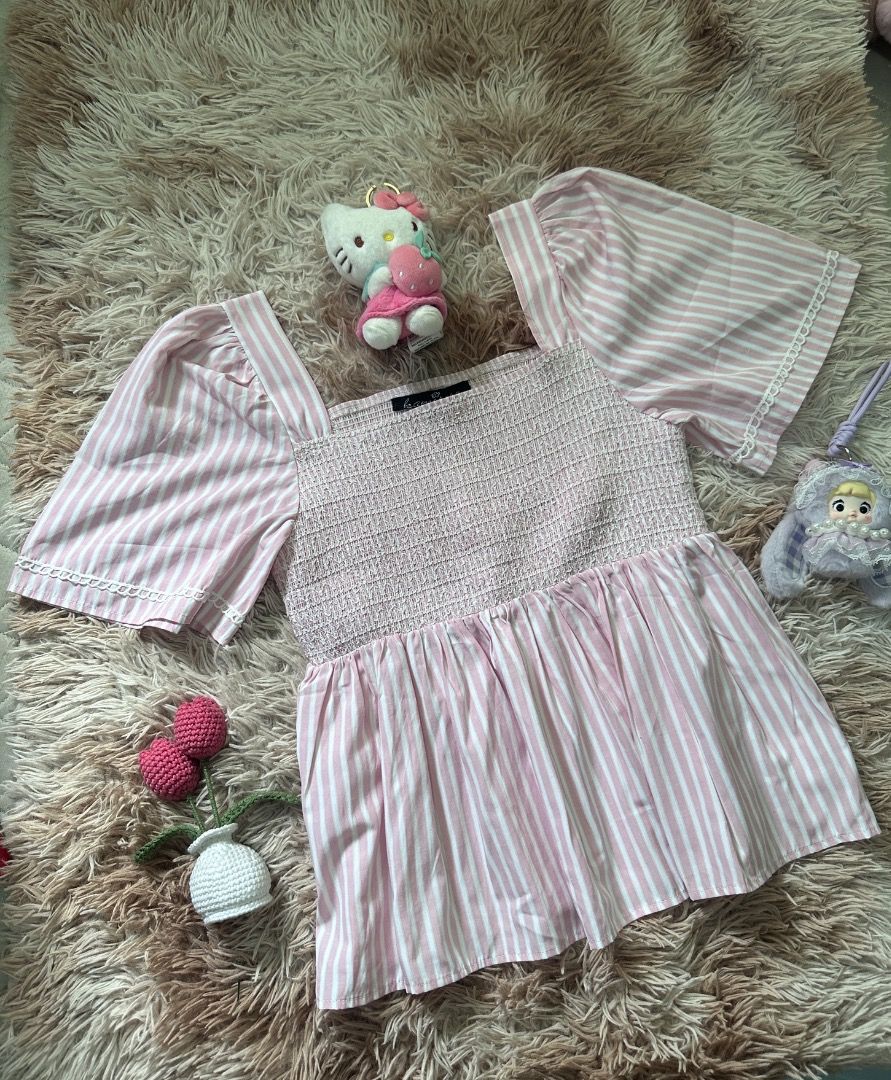Pink and White Striped Puff Sleeve Blouse (Category: Blouses) located in Rosario. Submitted by charmfashion (Listing ID 1467907130, Image 1). Description: - Design: Pink and white stripes with a flattering square neckline - Sleeves: Short puff sleeves with delicate lace trim on cuffs - Fit: Comfortable, stretchy smocked bodice and casual flared hem - Styling: Perfect to pair with high-waisted skirts or jeans - Condition: Brand new / Excellent qua