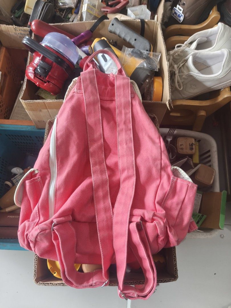 Pink Canvas Footstep Backpack with Chain and Patches (Category: Backpacks) located in Binan City. Submitted by makinpeso0622 (Listing ID 1467876174, Image 3). Description: - Color: Bright pink canvas - Design: 'Footstep', number 27, and peace sign patches with metal chain detail - Closure: Drawstring with double buckled straps - Pockets: Convenient side pockets with buckles - Straps: Adjustable shoulder straps for comfort - Interior: Clean white 