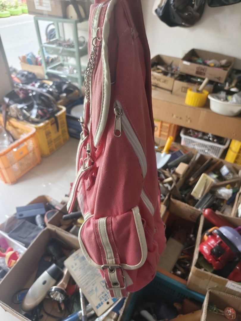 Pink Canvas Footstep Backpack with Chain and Patches (Category: Backpacks) located in Binan City. Submitted by makinpeso0622 (Listing ID 1467876174, Image 2). Description: - Color: Bright pink canvas - Design: 'Footstep', number 27, and peace sign patches with metal chain detail - Closure: Drawstring with double buckled straps - Pockets: Convenient side pockets with buckles - Straps: Adjustable shoulder straps for comfort - Interior: Clean white 