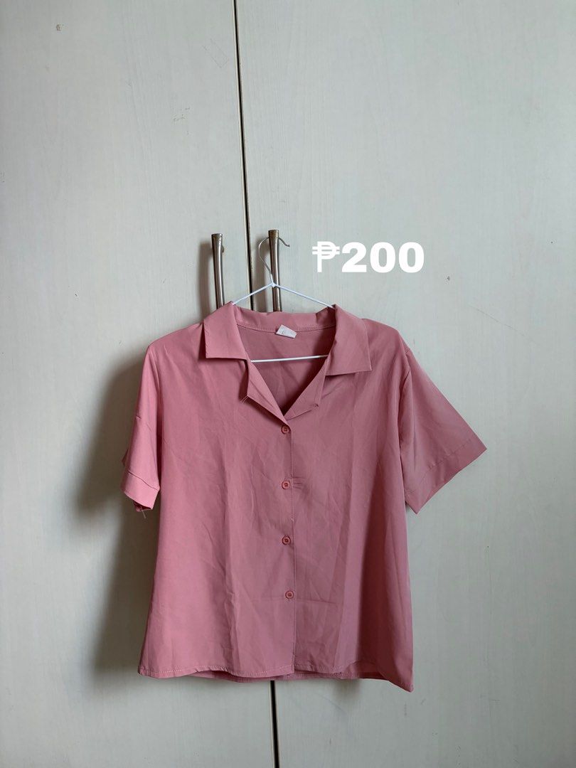Pink Short Sleeve Button Up Collared Blouse (Category: Blouses) located in Sariaya. Submitted by starstore.ph (Listing ID 1467888222, Image 1). Description: mop: gcash/maribank mod: jnt/lalamove/grab/meetup (mandaluyong or makati only) - Color: Dusty pink - Size: L - Style: Short-sleeve button-down with lapel collar and straight hem - Material: Lightweight fabric - Details: Four matching front buttons - Condition: Clean and ready to wear - Versat