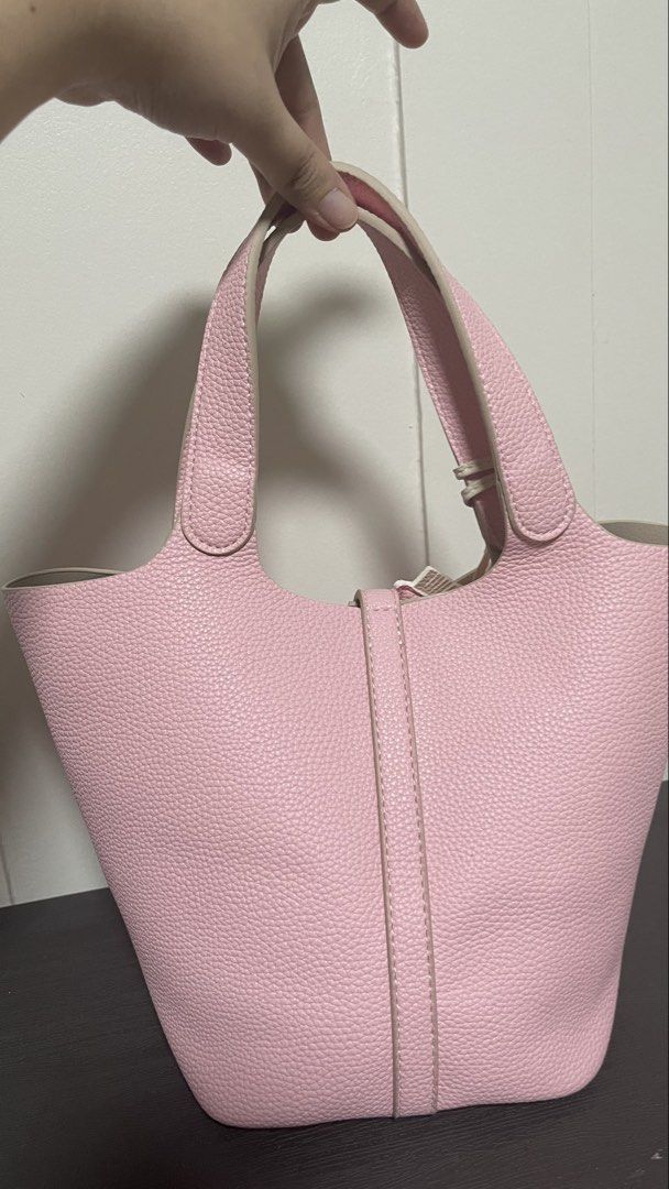 Pink Tote Bag with Pegasus Charm (Category: Tote Bags) located in Magalang. Submitted by josephinenl (Listing ID 1467898404, Image 2). Description: - Stylish textured pink bucket tote with sturdy handles - Elegant silver-tone lock hardware closure - Comes with a matching pegasus-shaped bag charm with white wings - Includes a zippered interior organizer pouch in grey herringbone fabric with pink trim - Perfect everyday bag for work, casual outings