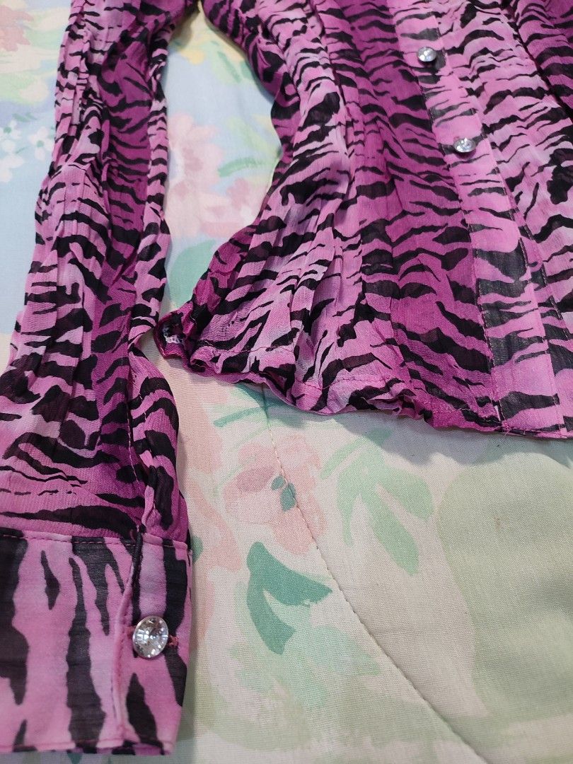 Pink Zebra Print Button-Up Blouse (Category: Blouses) located in Jaen. Submitted by roxantiago (Listing ID 1468038706, Image 3). Description: xs to s - Design: Pink & black animal print with crinkled sheer texture - Fit: Fitted silhouette with long sleeves and pointed collar - Details: Sparkly rhinestone buttons down the front and at cuffs - Condition: Excellent pre-loved condition - Mode of Payment: GCash, BPI, or Maya - Shipping: Fast shipping 