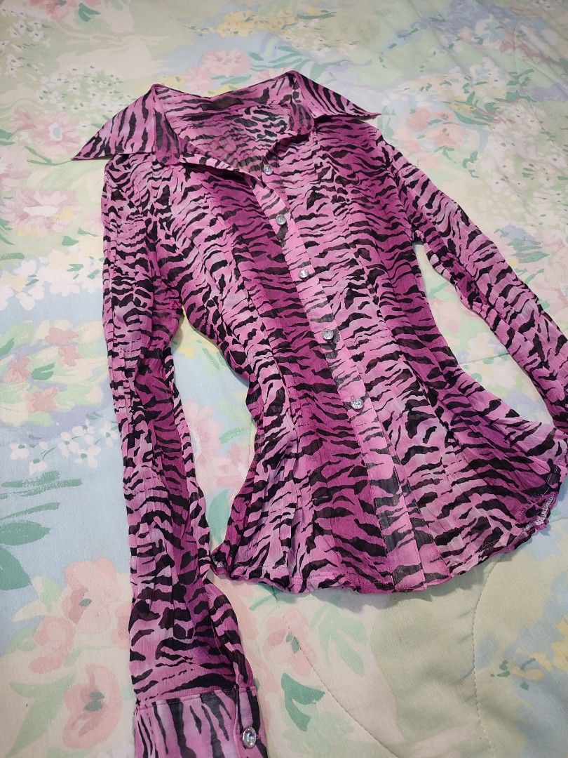 Pink Zebra Print Button-Up Blouse (Category: Blouses) located in Jaen. Submitted by roxantiago (Listing ID 1468038706, Image 2). Description: xs to s - Design: Pink & black animal print with crinkled sheer texture - Fit: Fitted silhouette with long sleeves and pointed collar - Details: Sparkly rhinestone buttons down the front and at cuffs - Condition: Excellent pre-loved condition - Mode of Payment: GCash, BPI, or Maya - Shipping: Fast shipping 