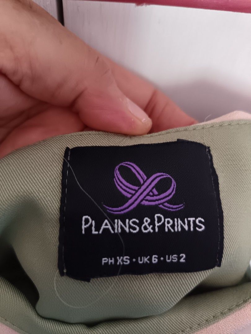 Plains & Prints Olive Green Off-Shoulder Top (Category: Sleeveless) located in Rizal. Submitted by shaynelove05 (Listing ID 1467906640, Image 3). Description: Olive green off-shoulder top from Plains & Prints. Contrasting nude pink collar and shoulder flap overlay. Sleeveless cut. Tag says PH XS, UK 6, US 2. Clean solid fabric, lightweight material. Easy to style with skirts or trousers for casual outings or smart casual wear. Almost new used onc