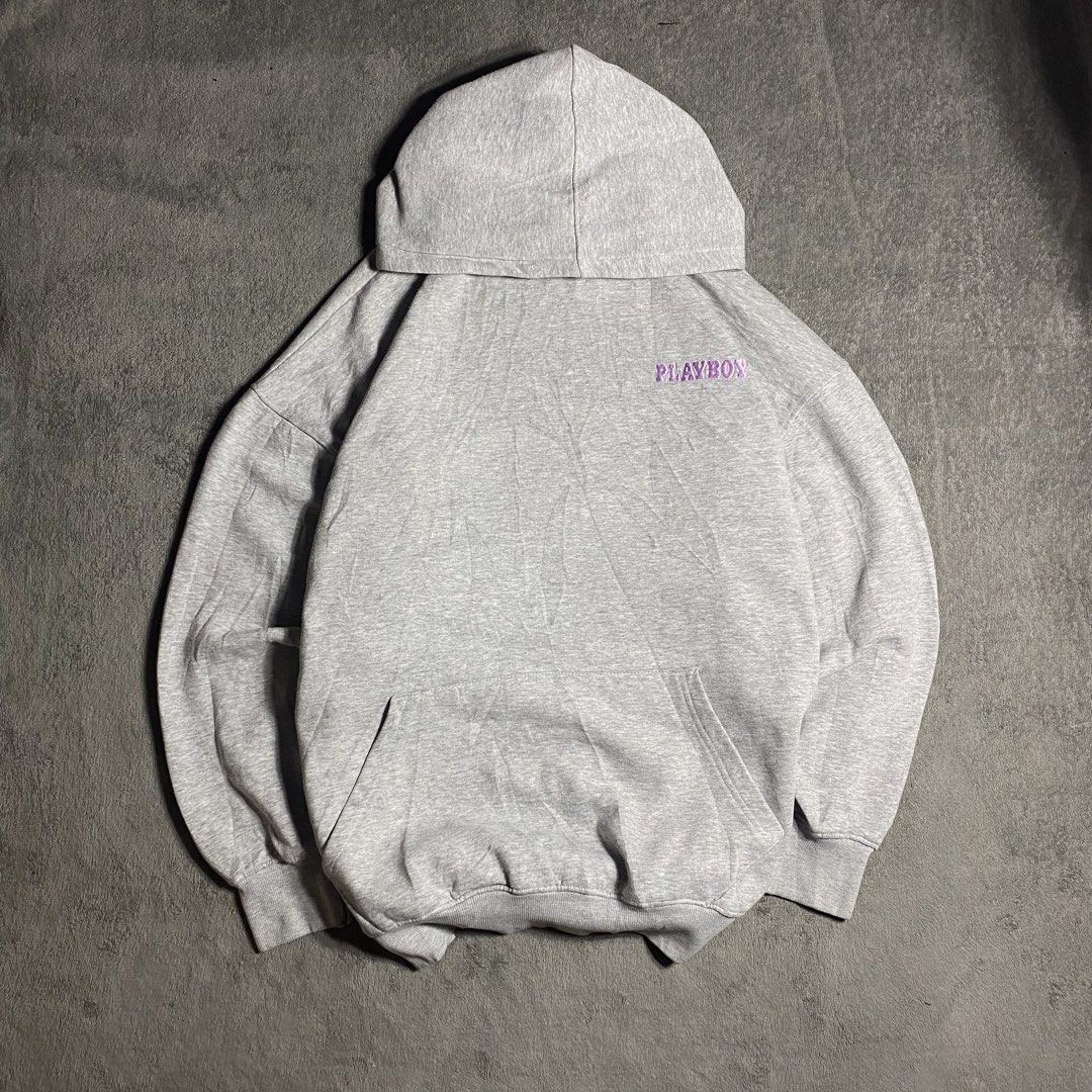 Playboy Grey Graphic Hoodie (Category: Coats, Jackets and Outerwear) located in Manila. Submitted by thrifturfit_star (Listing ID 1467845279, Image 1). Description: - Style: Grey Playboy hoodie with a relaxed, oversized fit - Back Design: Large, eye-catching magazine cover print - Front Detail: Purple embroidered Playboy logo on the chest - Features: Adjustable drawstring hood, front kangaroo pocket, ribbed cuffs and hem - Condition: Shows some s