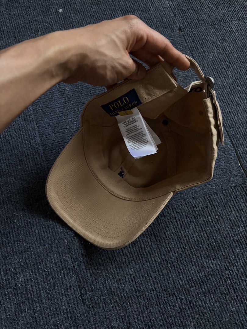 Polo Ralph Lauren Beige Baseball Cap (Category: Caps & Hats) located in Manila. Submitted by toys_hats005 (Listing ID 1467957339, Image 3). Description: - Authentic Polo Ralph Lauren baseball cap in classic beige - 100% comfortable cotton material - Signature embroidered pony logo on the front - POLO embroidery detail above the back strap - Adjustable metal buckle closure for a custom fit - One size fits most - Clean and ready to wear.