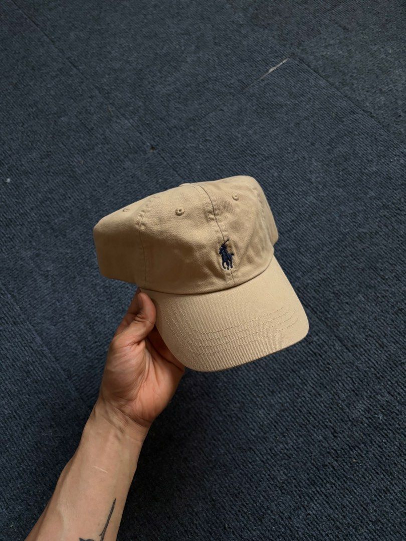 Polo Ralph Lauren Beige Baseball Cap (Category: Caps & Hats) located in Manila. Submitted by toys_hats005 (Listing ID 1467957339, Image 1). Description: - Authentic Polo Ralph Lauren baseball cap in classic beige - 100% comfortable cotton material - Signature embroidered pony logo on the front - POLO embroidery detail above the back strap - Adjustable metal buckle closure for a custom fit - One size fits most - Clean and ready to wear.